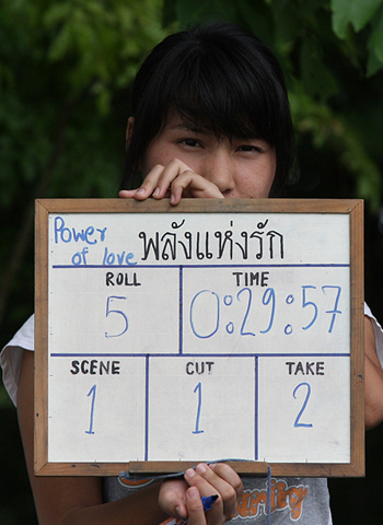 ホワイトボード製のカチンコをもつノンヌットさん。